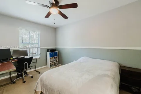 a bedroom with a bed and a desk