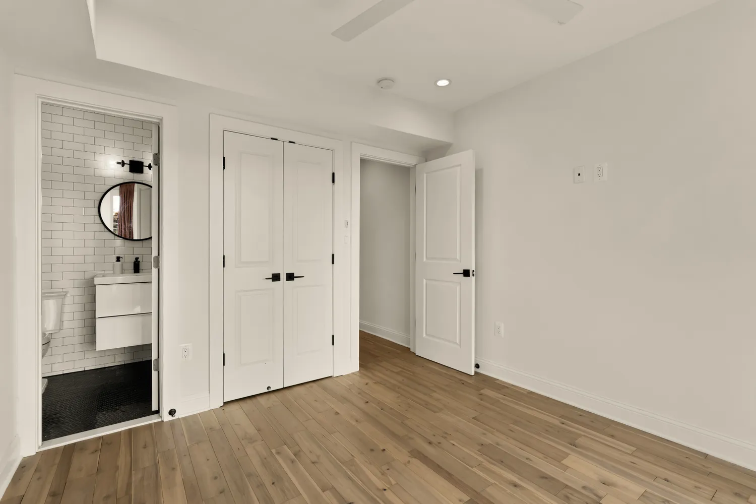 a view of a hallway with wooden floor