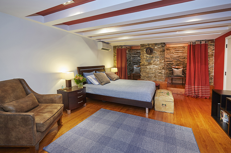 308 West 19th Street, Unit GARDEN Manhattan, NY 10011 - Photo 12 of 18 a living room with furniture and a flat screen tv