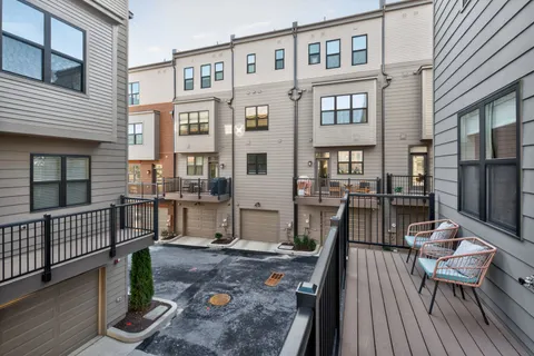 a balcony with table and chairs
