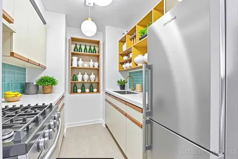 a kitchen with stainless steel appliances granite countertop a stove a sink and a refrigerator