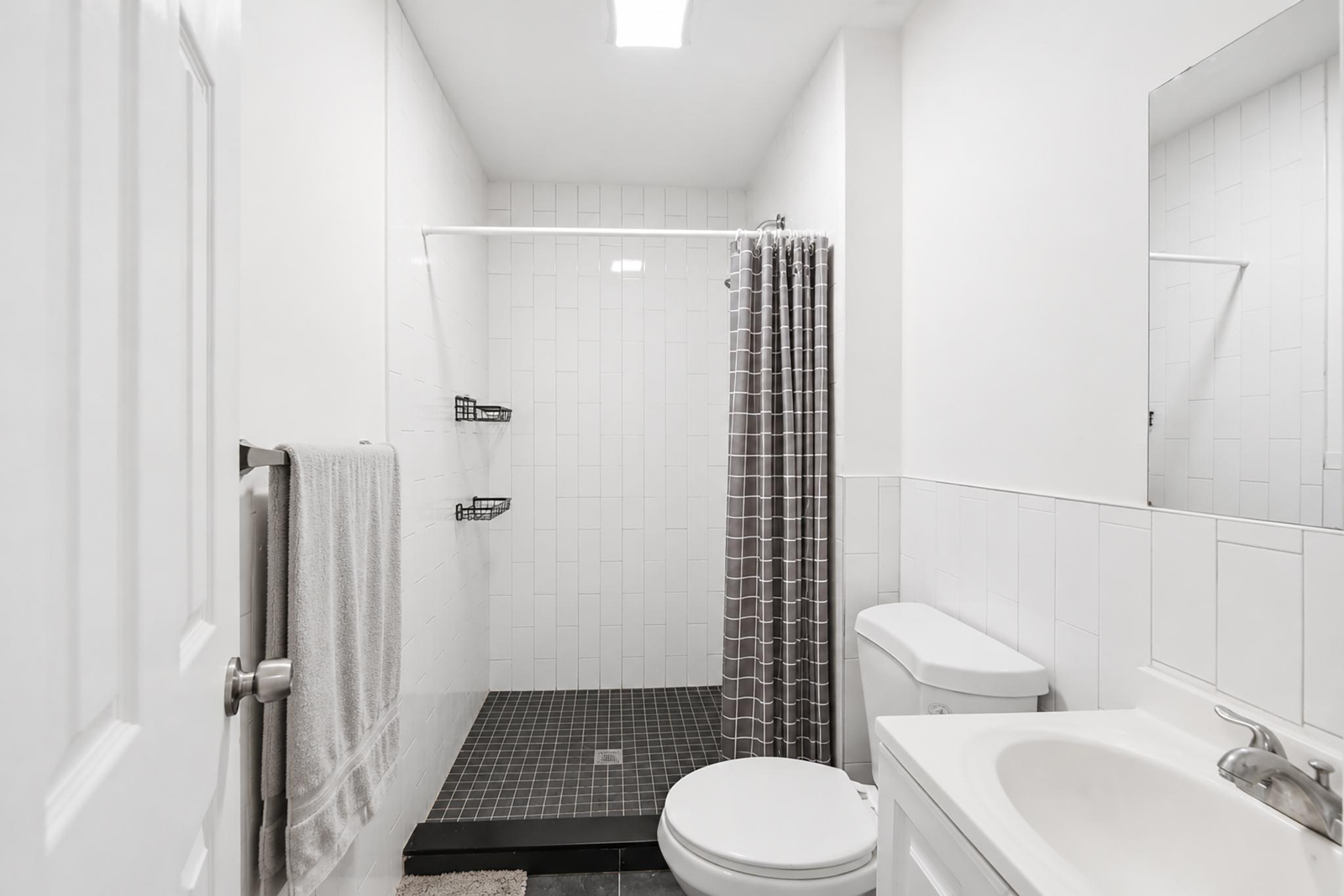 205 West 103rd Street, Unit 6B Manhattan, NY 10025 - Photo 9 of 11 a bathroom with a toilet a sink and shower