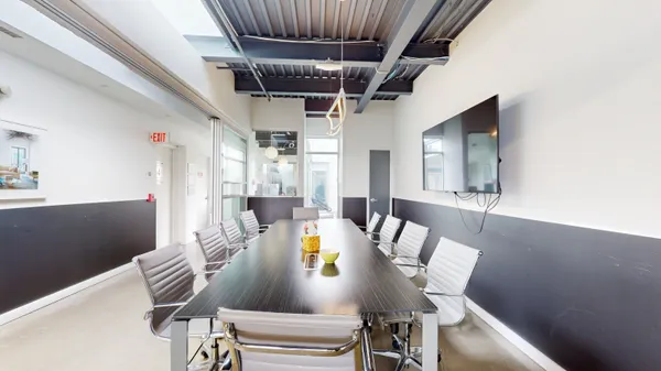 a dining room with furniture and wooden floor