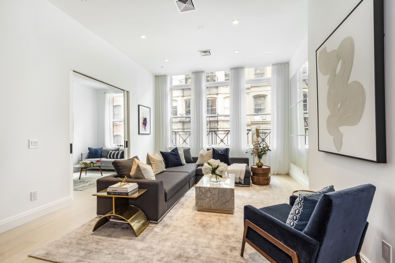 106 Franklin Street, Unit PH Manhattan, NY 10013 - Photo 2 of 13 a living room with furniture and a large window