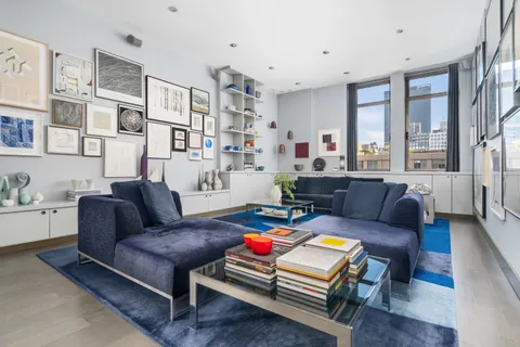 a living room with furniture and a bookshelf