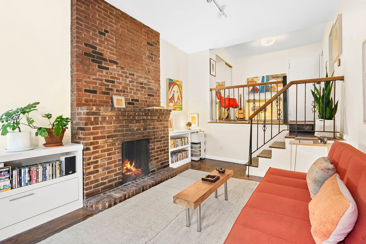 a living room with furniture a fireplace and a book shelf