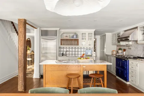 a kitchen with stainless steel appliances kitchen island granite countertop a sink and cabinets