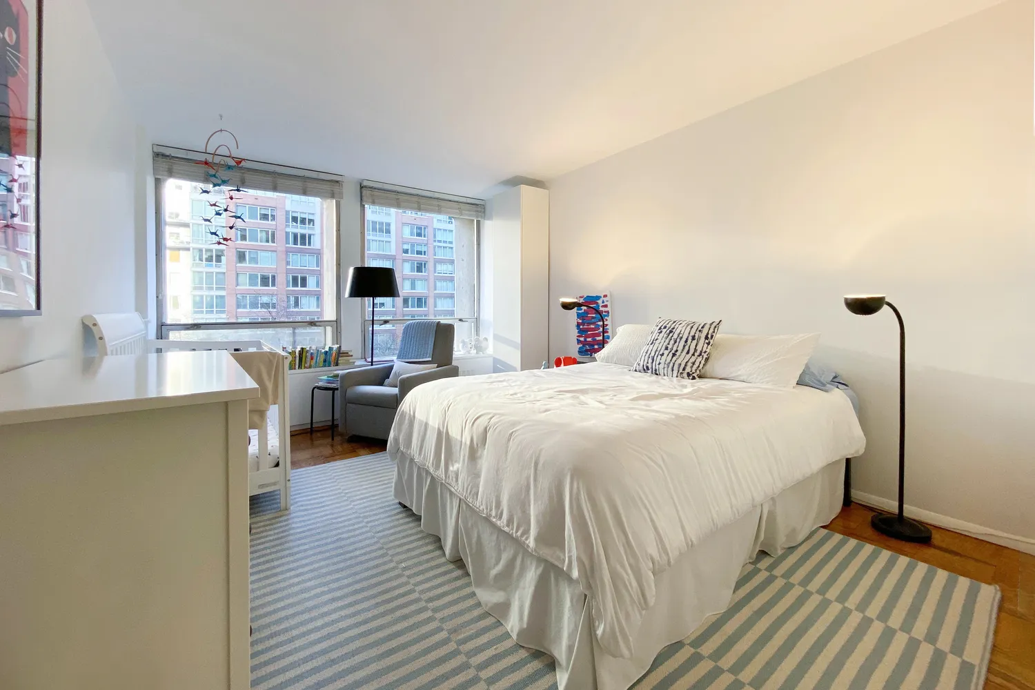 a spacious bedroom with a bed and a large window