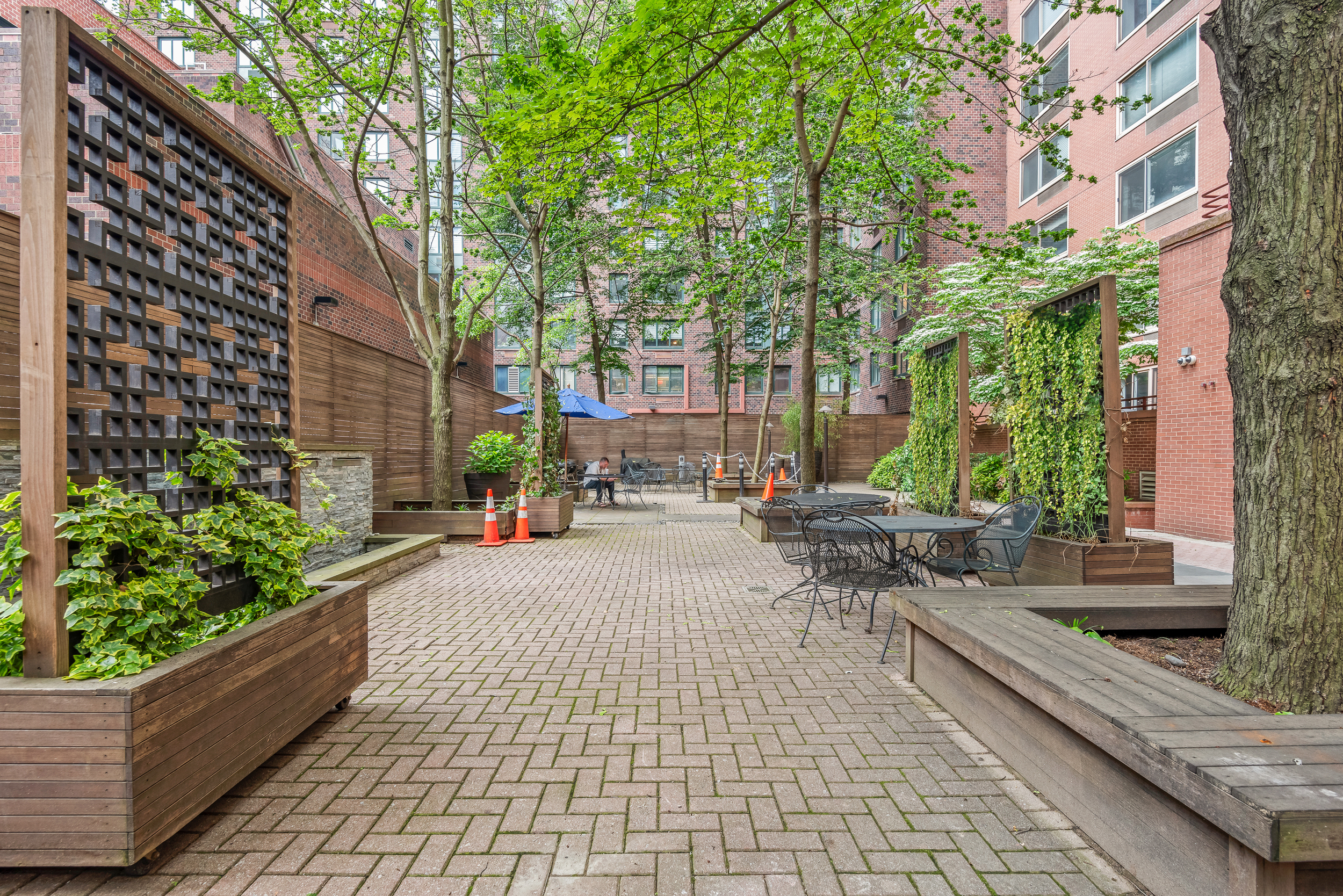 250 South End Avenue, Unit 3F Manhattan, NY 10280 - Photo 7 of 11 a view of a patio with couches and chairs with wooden fence