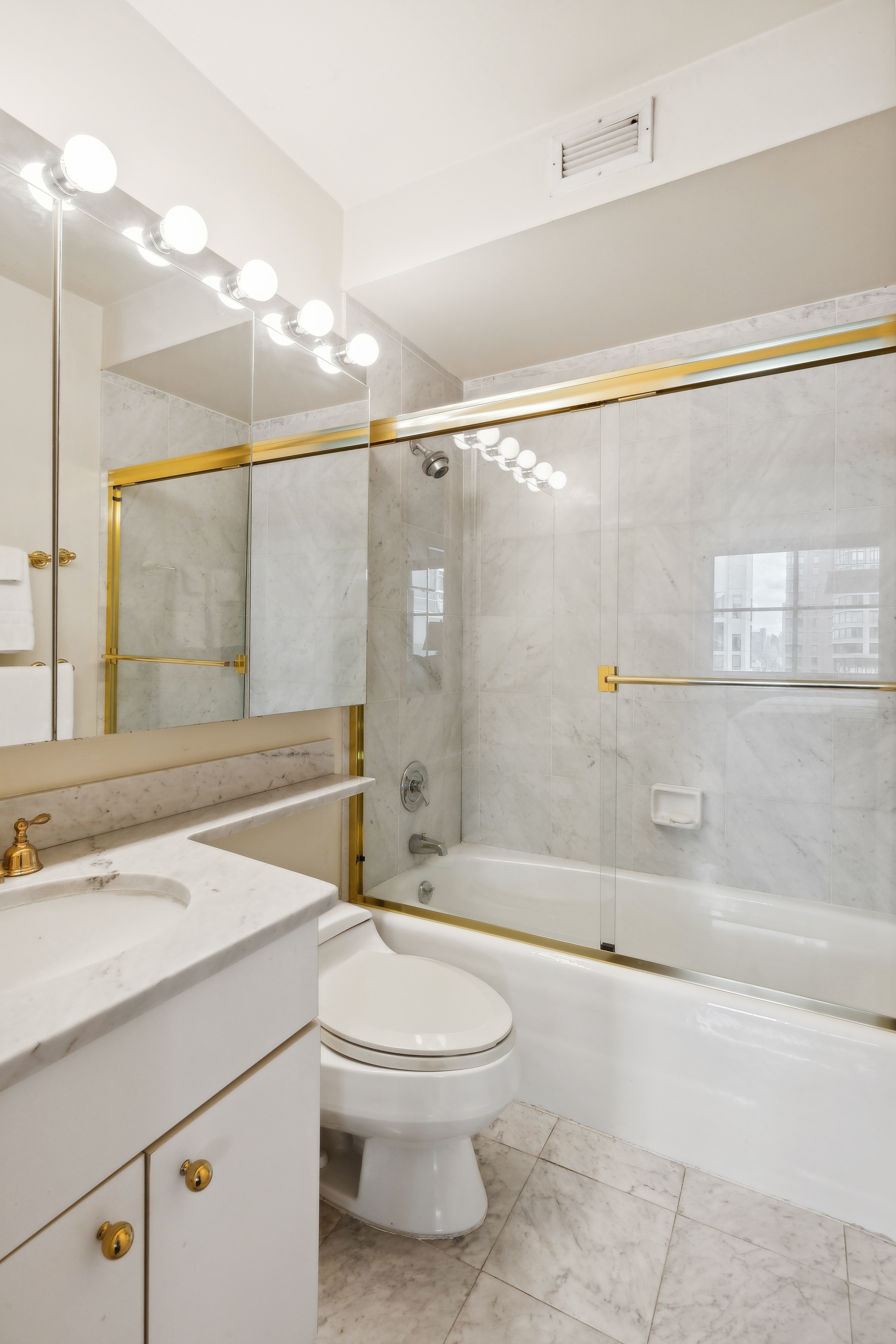 235 East 40th Street, Unit 37C Manhattan, NY 10016 - Photo 5 of 10 a bathroom with a sink a toilet and shower