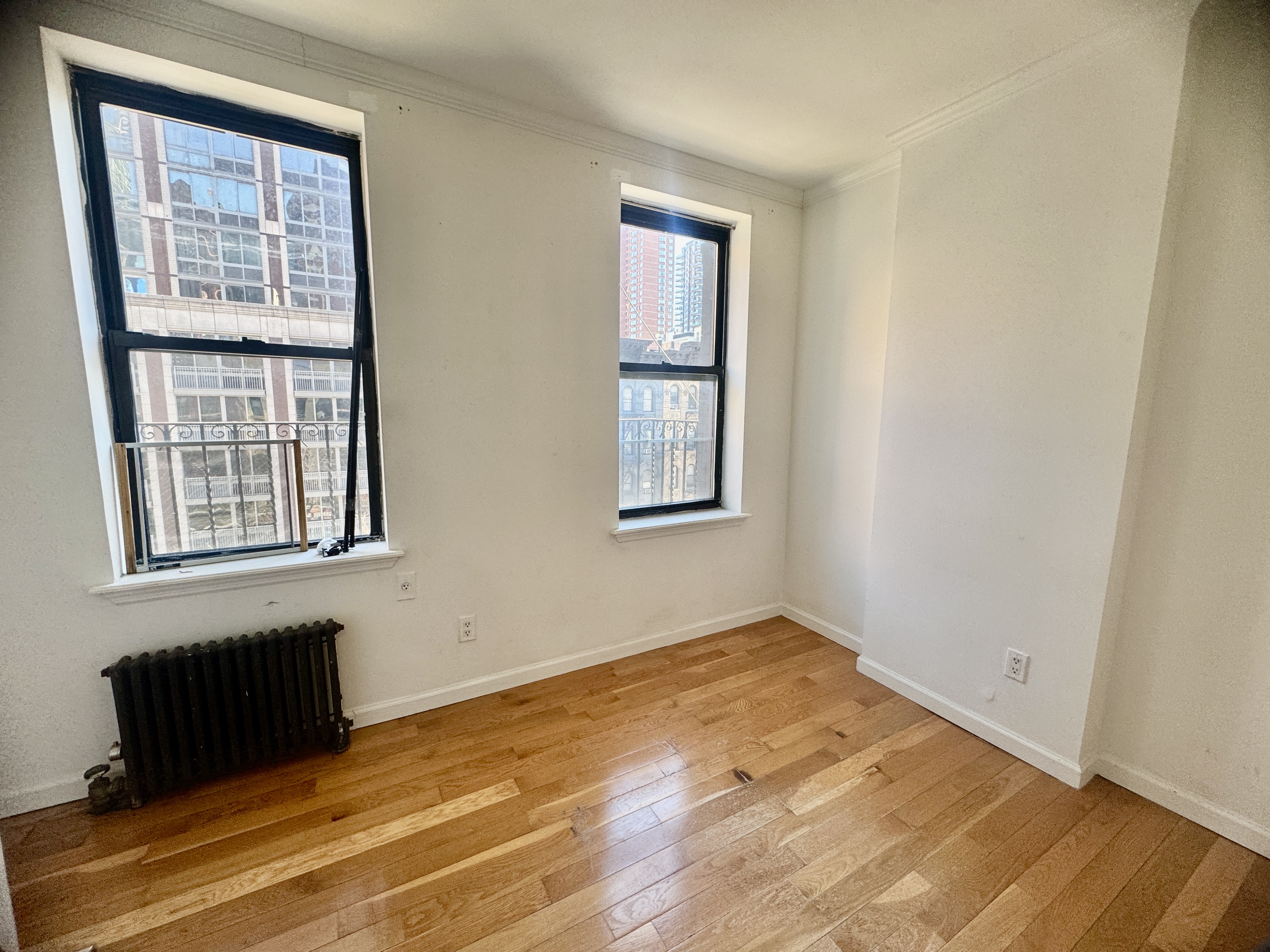 1773 1st Avenue, Unit 18 Manhattan, NY 10128 - Photo 4 of 10 a view of an empty room with a window