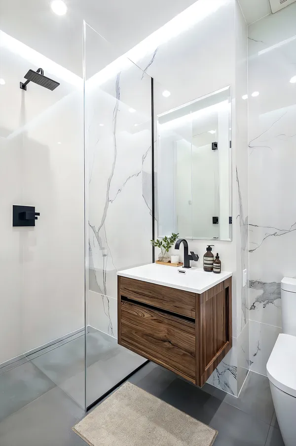 a bathroom with a sink a toilet and shower