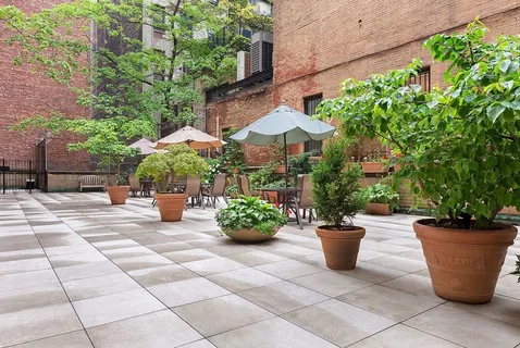 a view of a patio with potted plants and a fountain