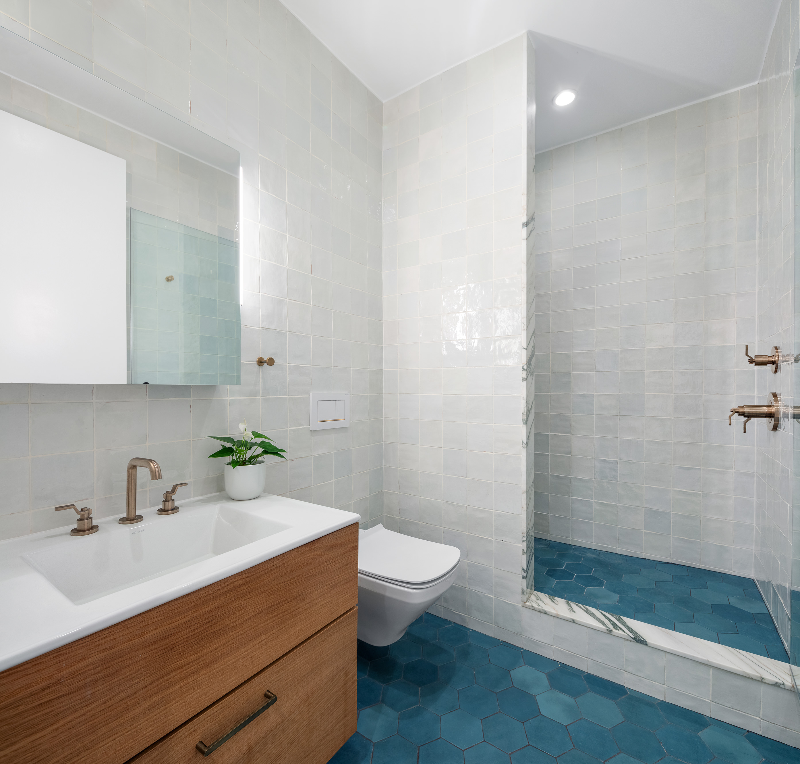 143 West 27th Street, Unit 2R Manhattan, NY 10001 - Photo 9 of 13 a bathroom with a sink a toilet and shower