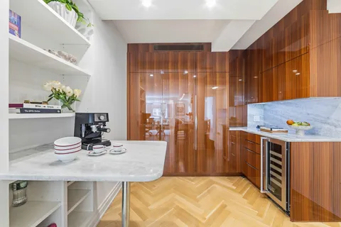 a kitchen with a table chairs and refrigerator