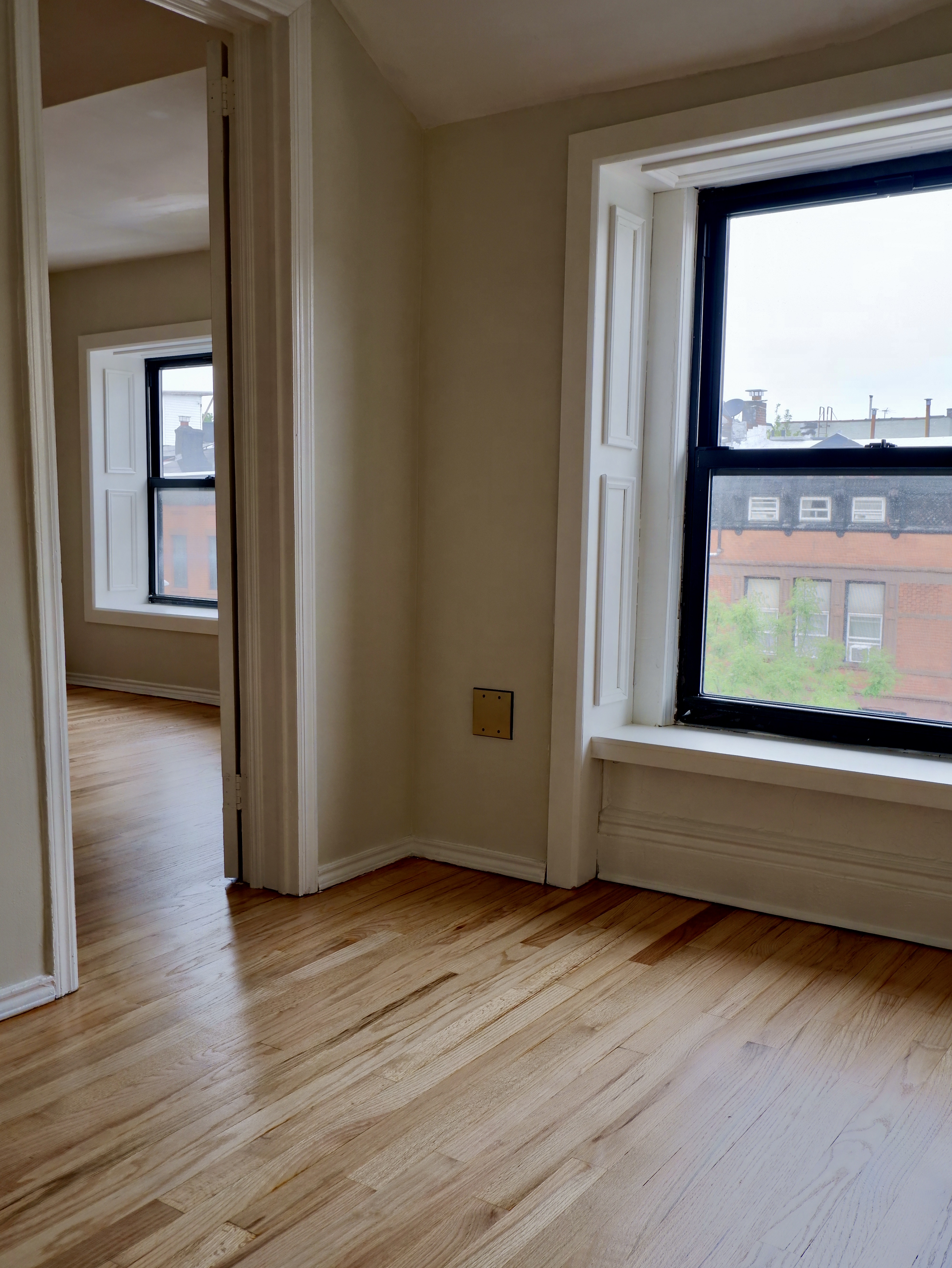 132 Decatur Street, Unit 3 Brooklyn, NY 11216 - Photo 8 of 17 a view of a room with wooden floor and a window