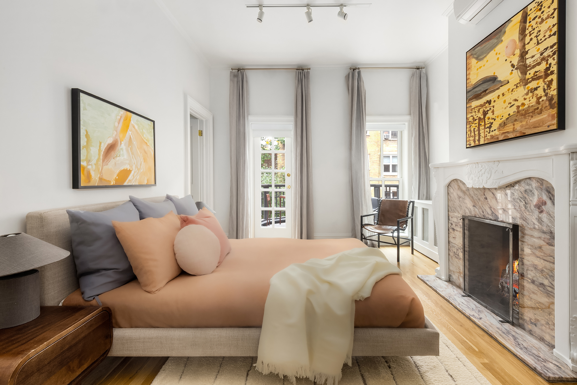 112 West 13th Street Manhattan, NY 10011 - Photo 26 of 46 a bedroom with furniture and a fireplace