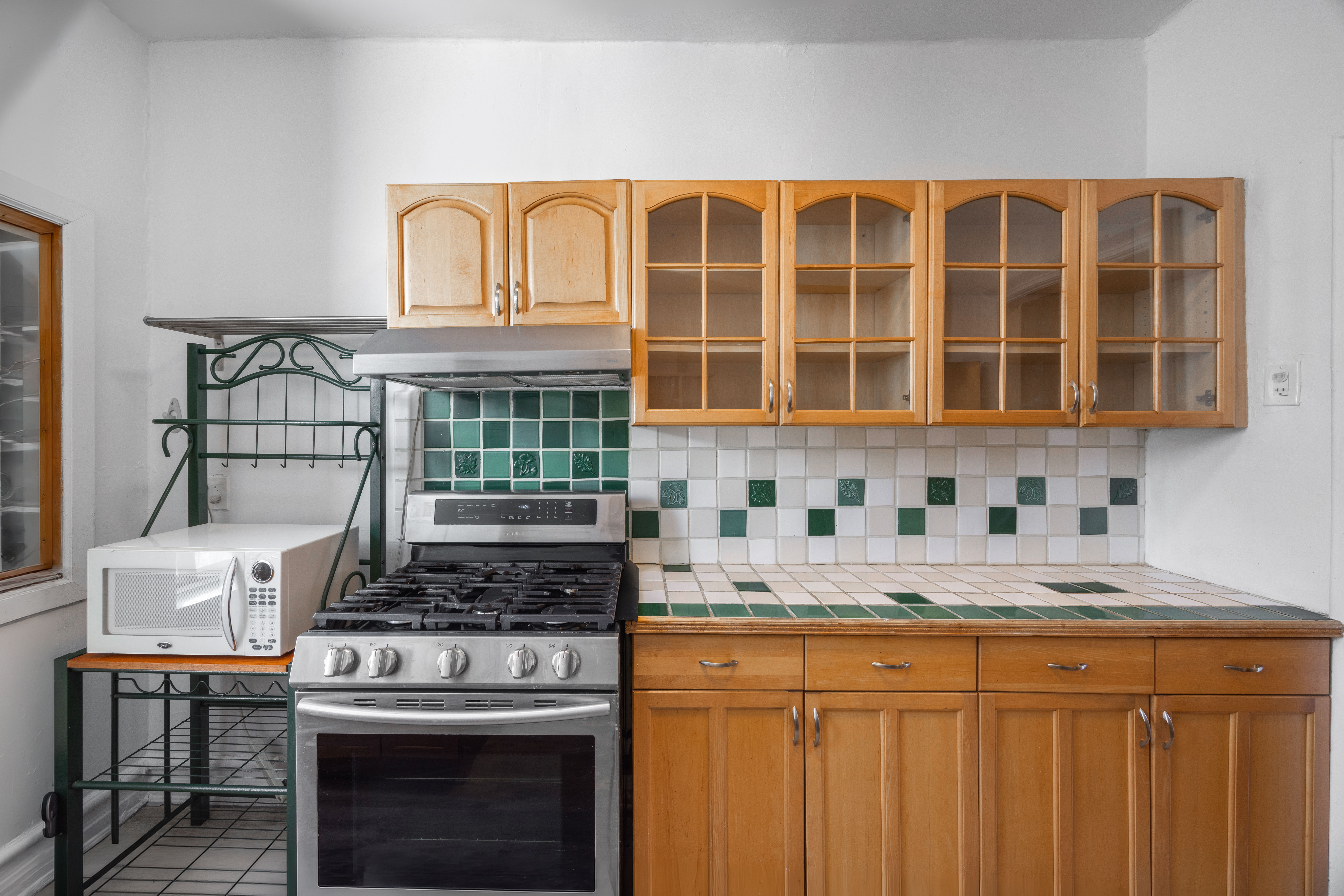179 Ocean Parkway, Unit 4H Brooklyn, NY 11218 - Photo 5 of 11 a kitchen with stainless steel appliances granite countertop a stove and a white cabinets