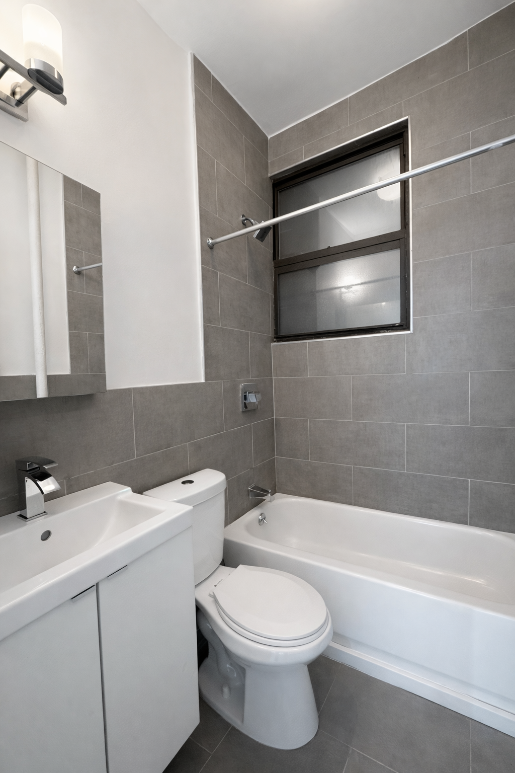 164 West 128th Street, Unit 3C Manhattan, NY 10027 - Photo 7 of 8 a bathroom with a toilet a sink and bathtub
