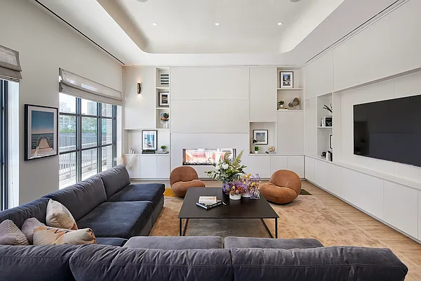 160 Front Street, Unit 517 Brooklyn, NY 11201 - Photo 13 of 14 a living room with furniture and a flat screen tv