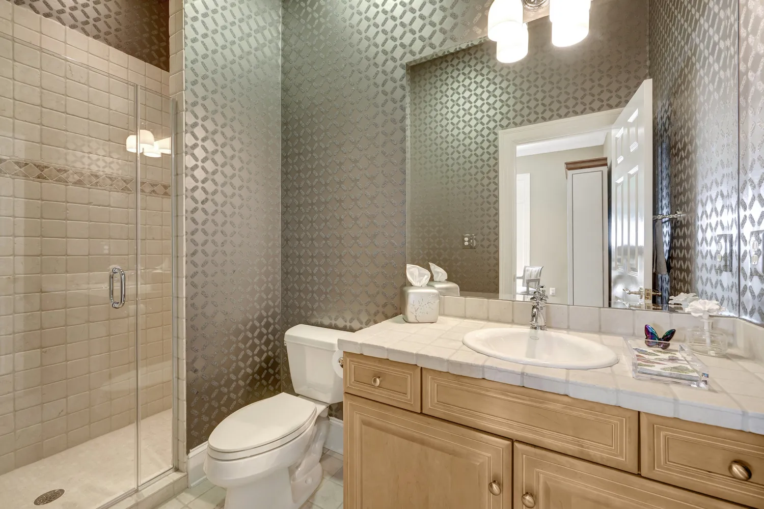 a bedroom with a bed and large windows