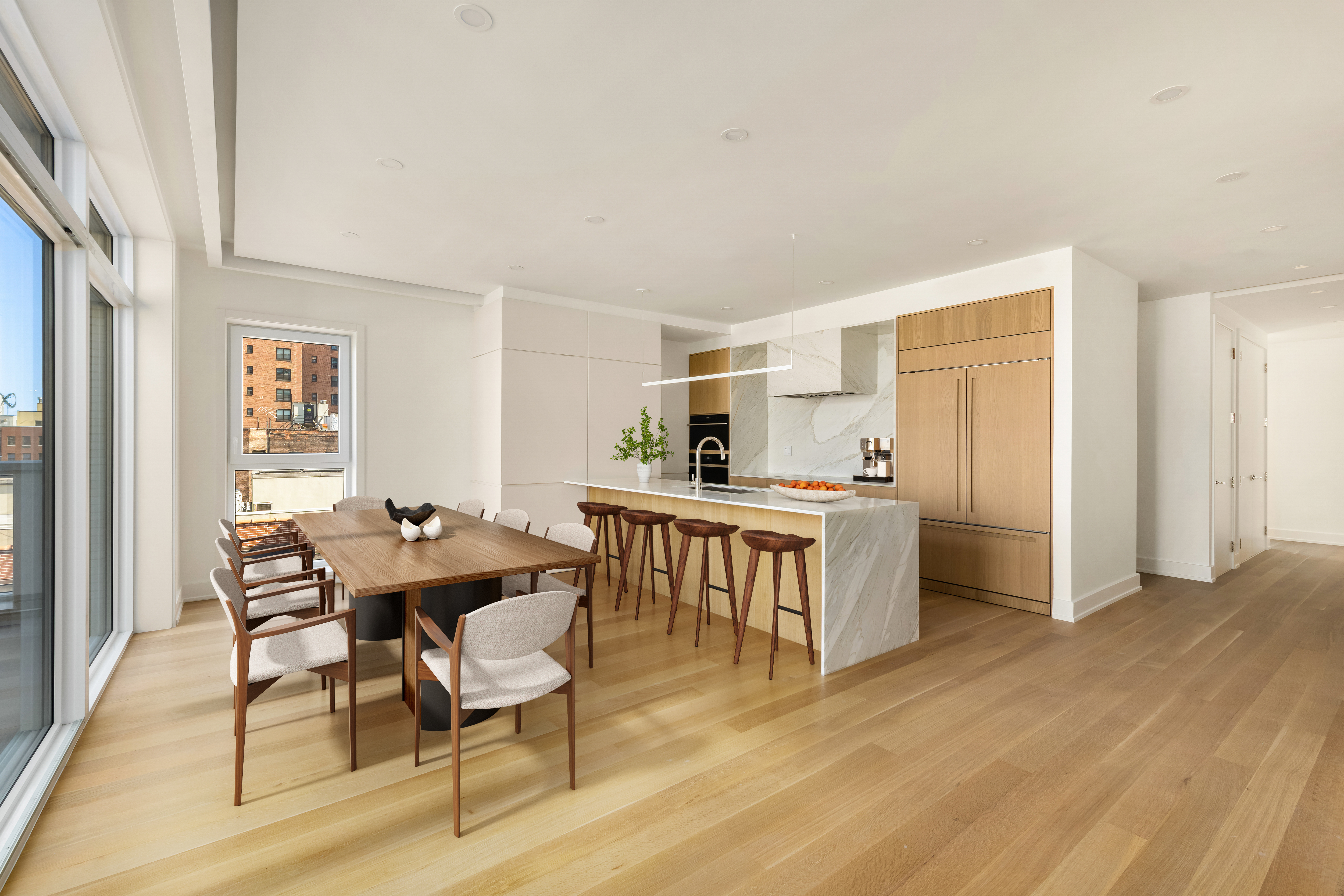420 East 75th Street, Unit PH Manhattan, NY 10021 - Photo 2 of 24 a kitchen with a dining table chairs and refrigerator