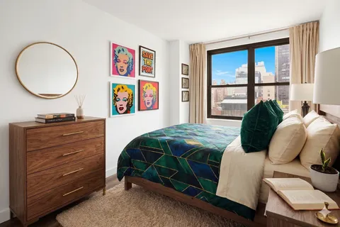 a bedroom with a bed and a mirror