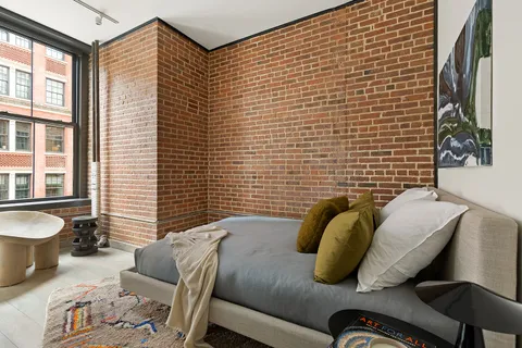 a bedroom with furniture and a window