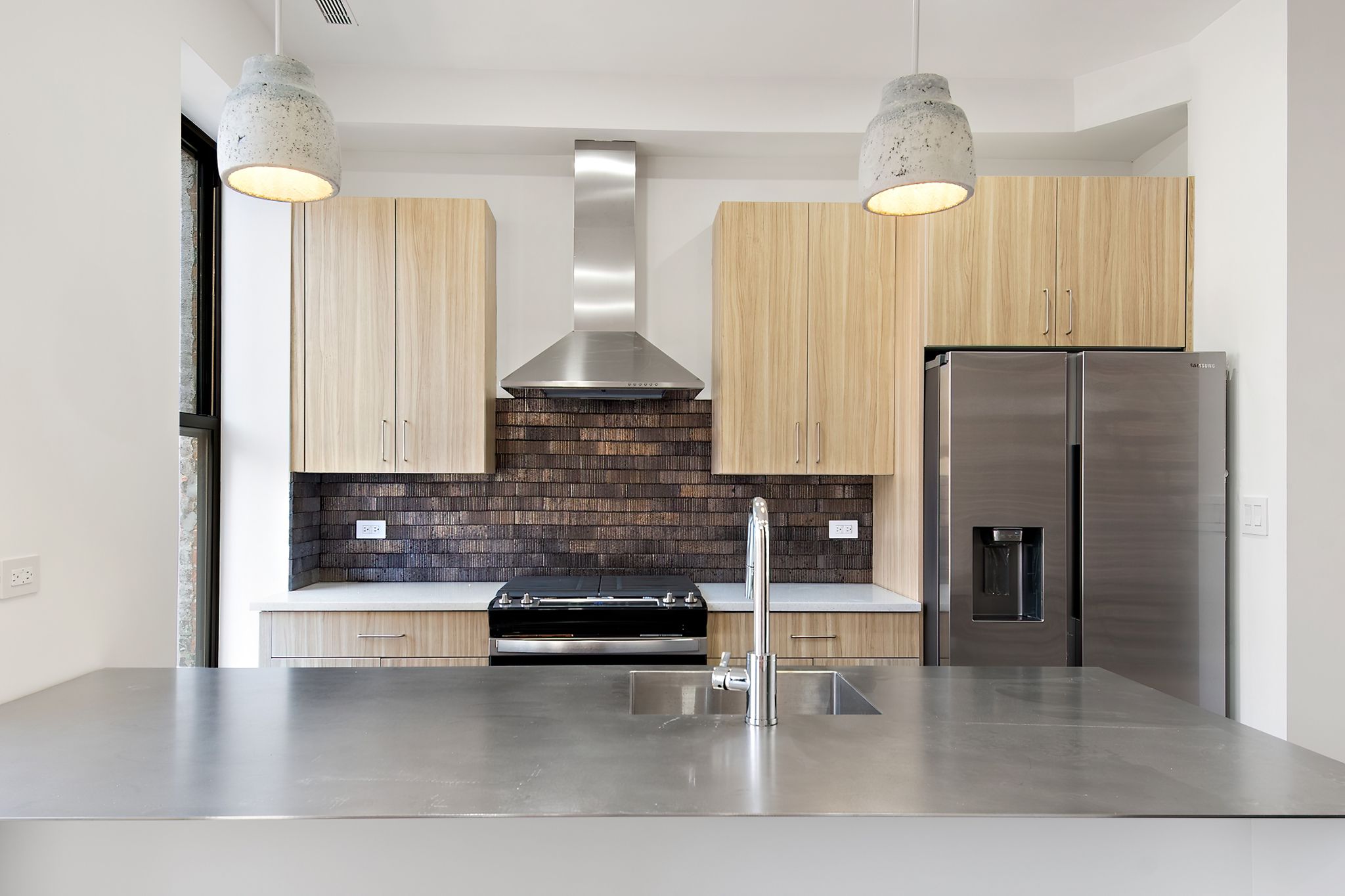 181 Kosciuszko Street Brooklyn, NY 11216 - Photo 6 of 20 a kitchen with stainless steel appliances kitchen island granite countertop a refrigerator and cabinets