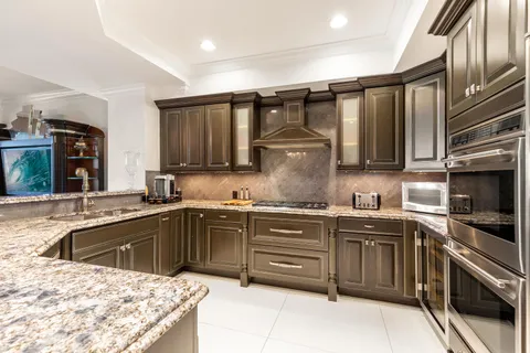 a kitchen with a sink stove and cabinets
