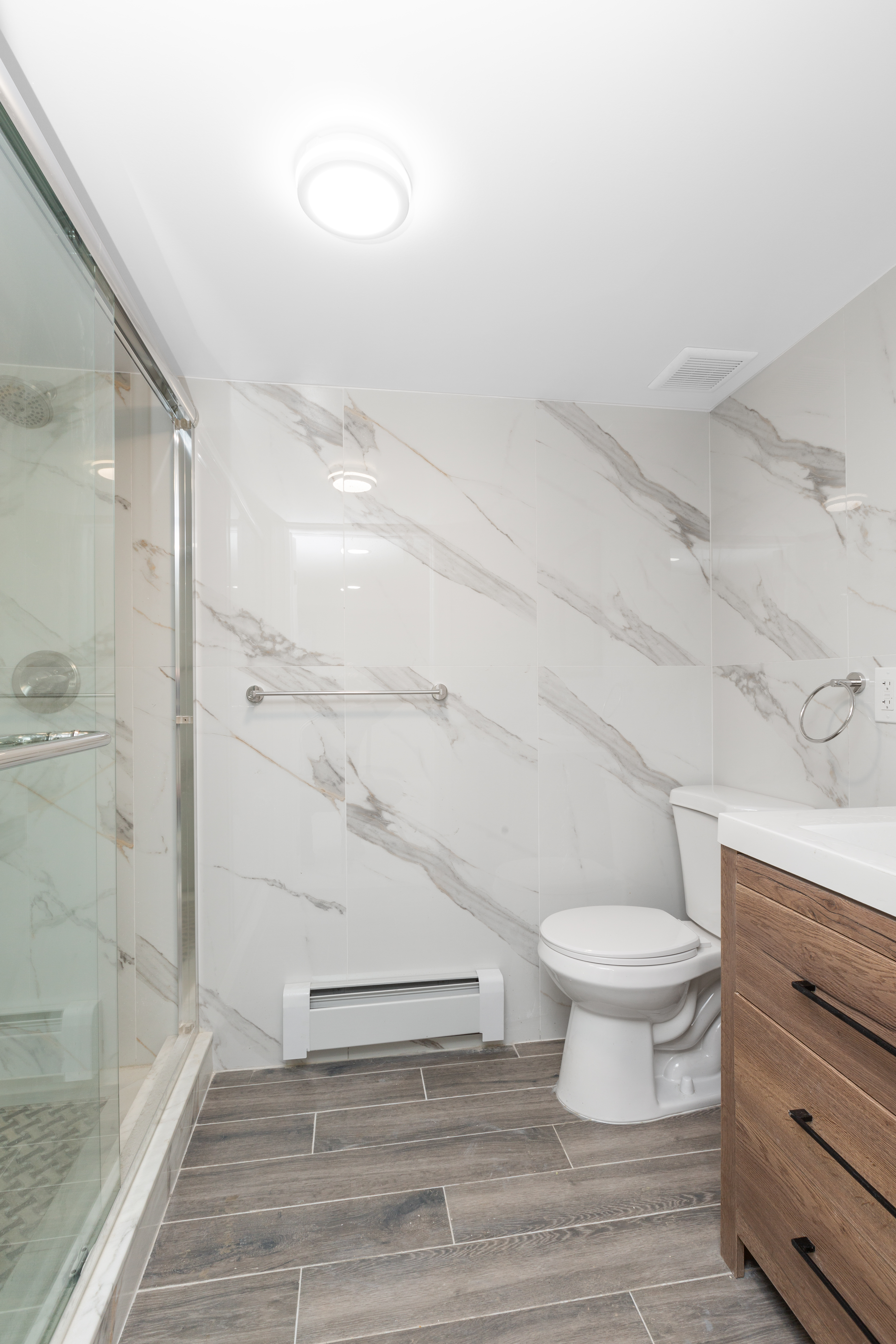 143-10 Shore Avenue Queens, NY 11435 - Photo 25 of 30 a bathroom with a toilet and a shower