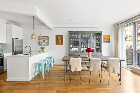 a view of a dining room with furniture wooden floor and a rug