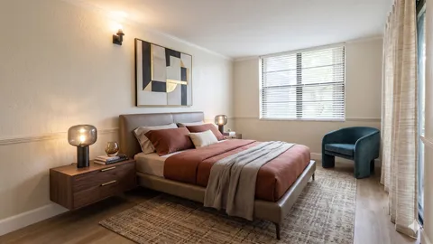 a bedroom with a bed wooden floor and lamp