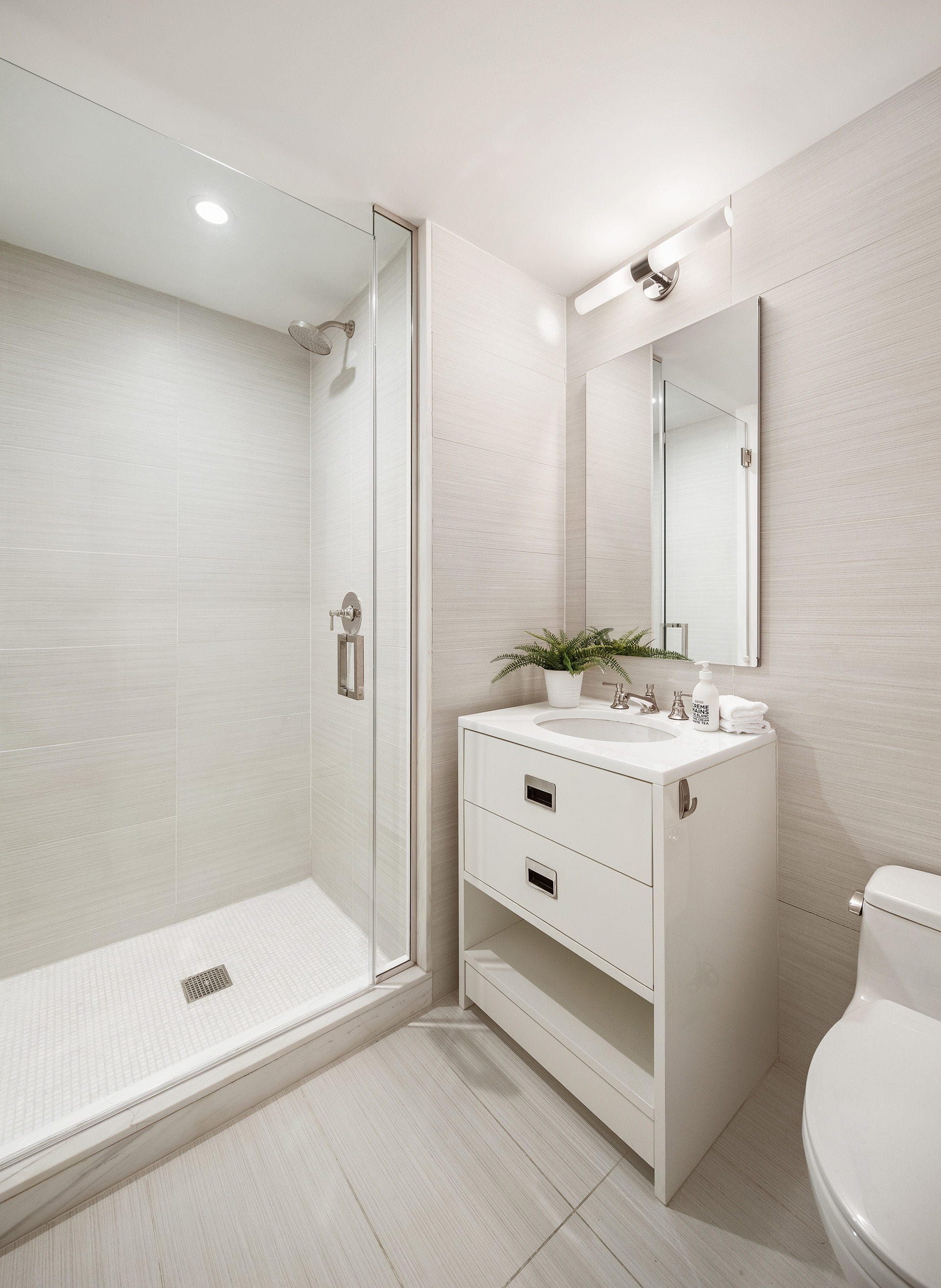 305 East 85th Street, Unit 5B Manhattan, NY 10028 - Photo 10 of 11 a bathroom with a sink a toilet and shower