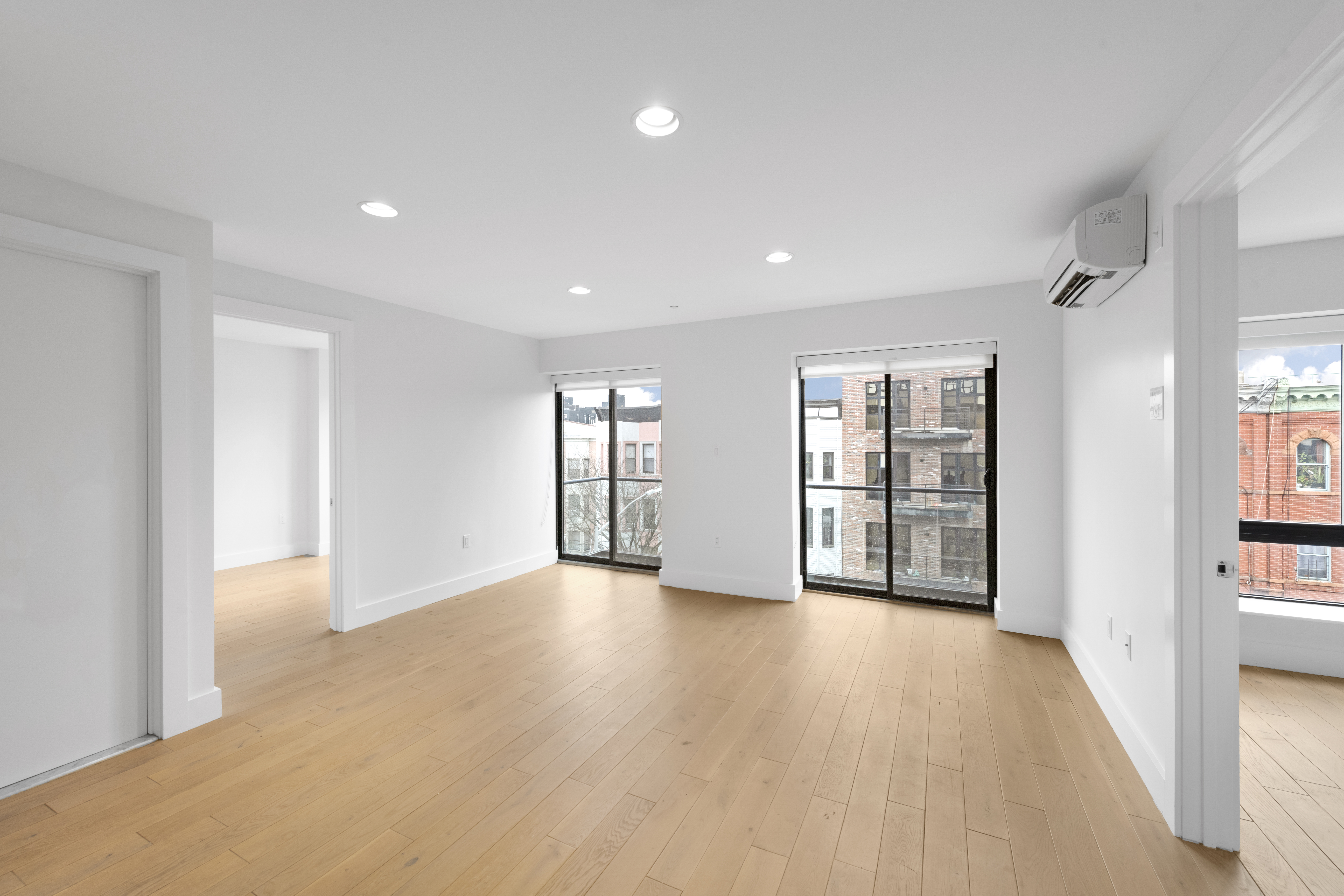 1164 Greene Avenue, Unit PHB Brooklyn, NY 11221 - Photo 3 of 16 a view of an empty room with a window and wooden floor