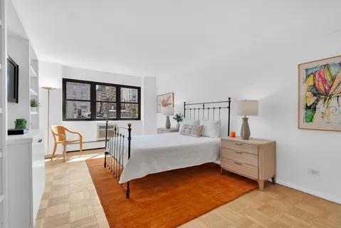 a bedroom with furniture and window