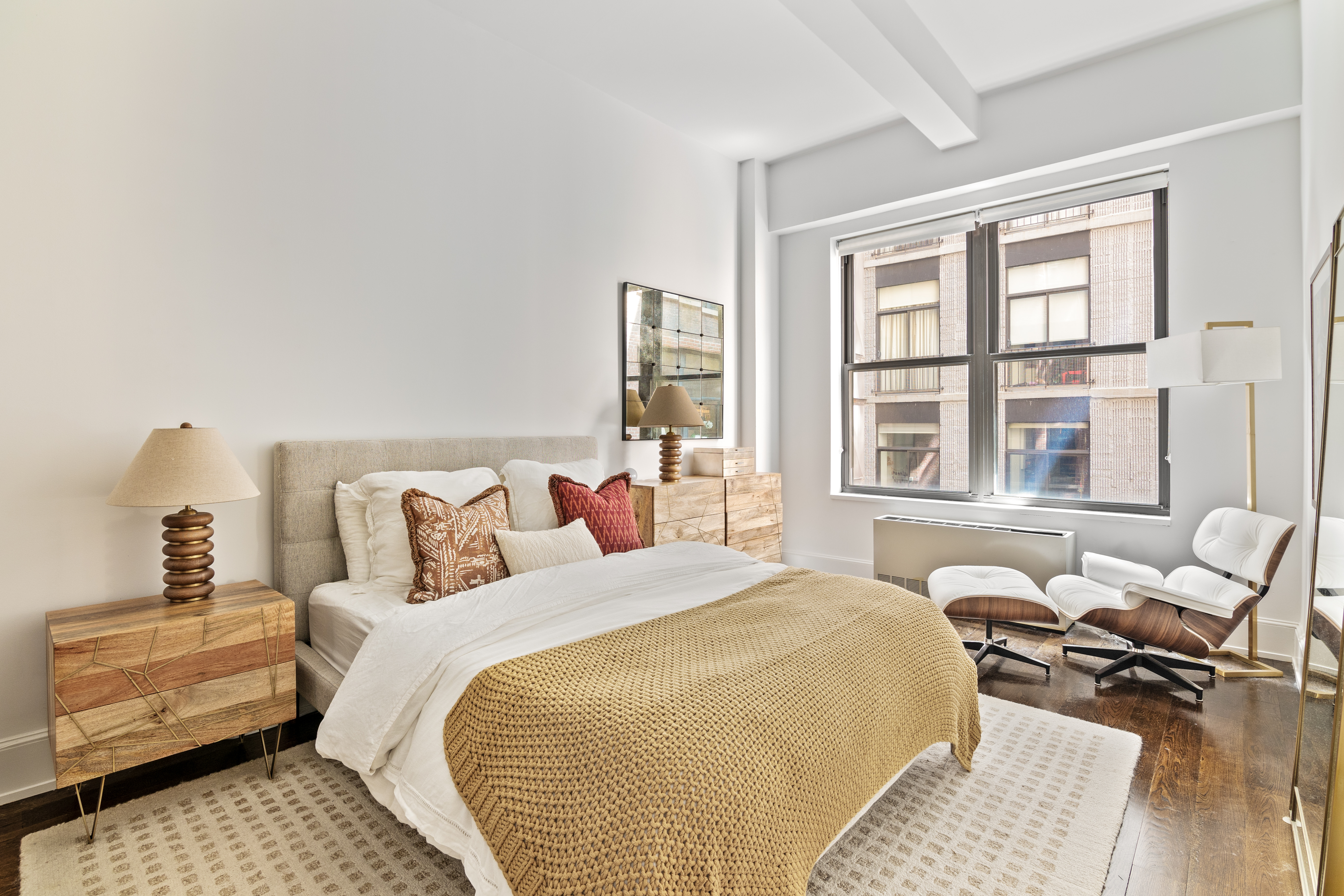 260 Park Avenue South, Unit 6I Manhattan, NY 10010 - Photo 4 of 9 a bedroom with a bed and wooden floor