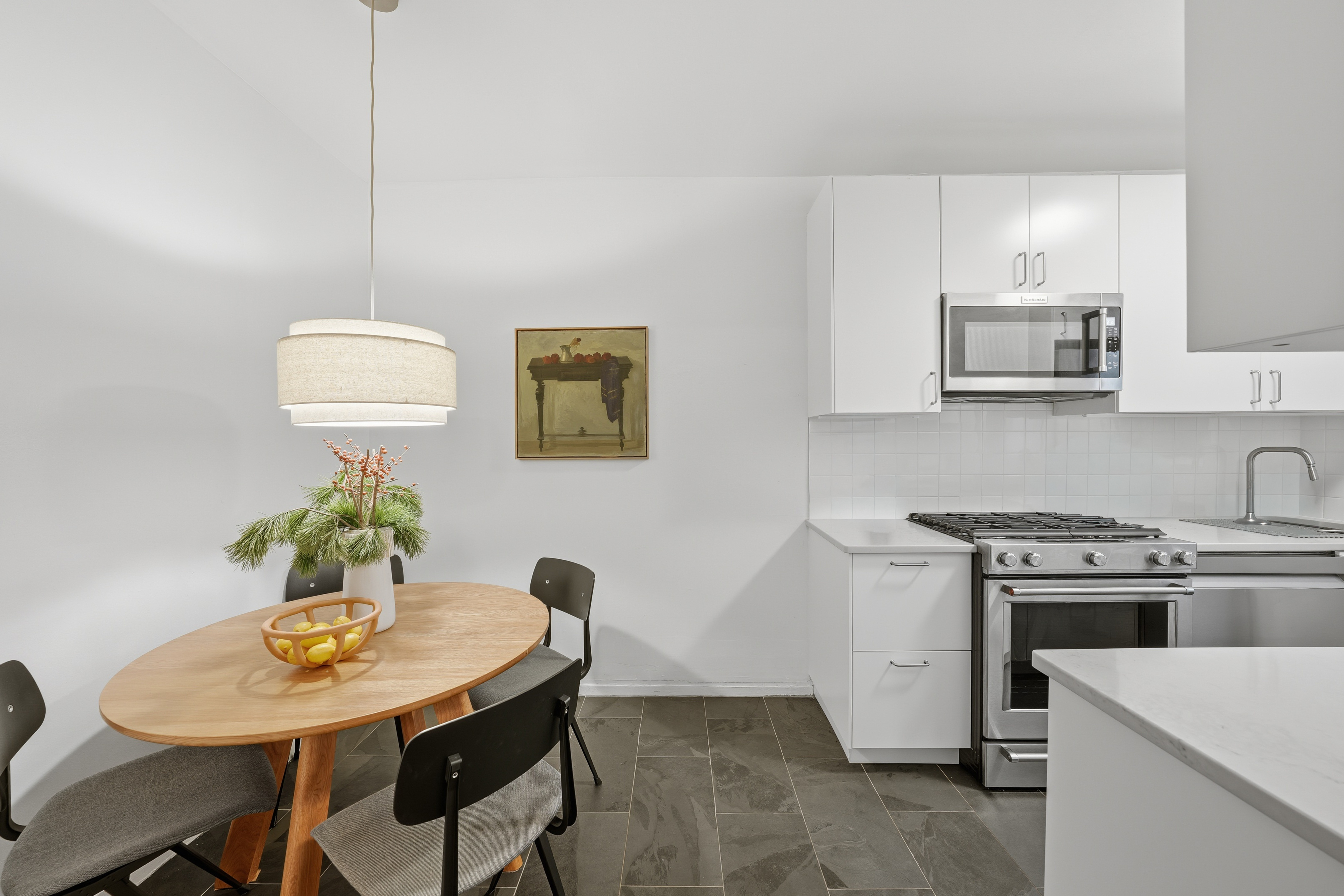 80 Avenue P, Unit D14 Brooklyn, NY 11204 - Photo 8 of 19 a kitchen with stainless steel appliances a stove a table and chair
