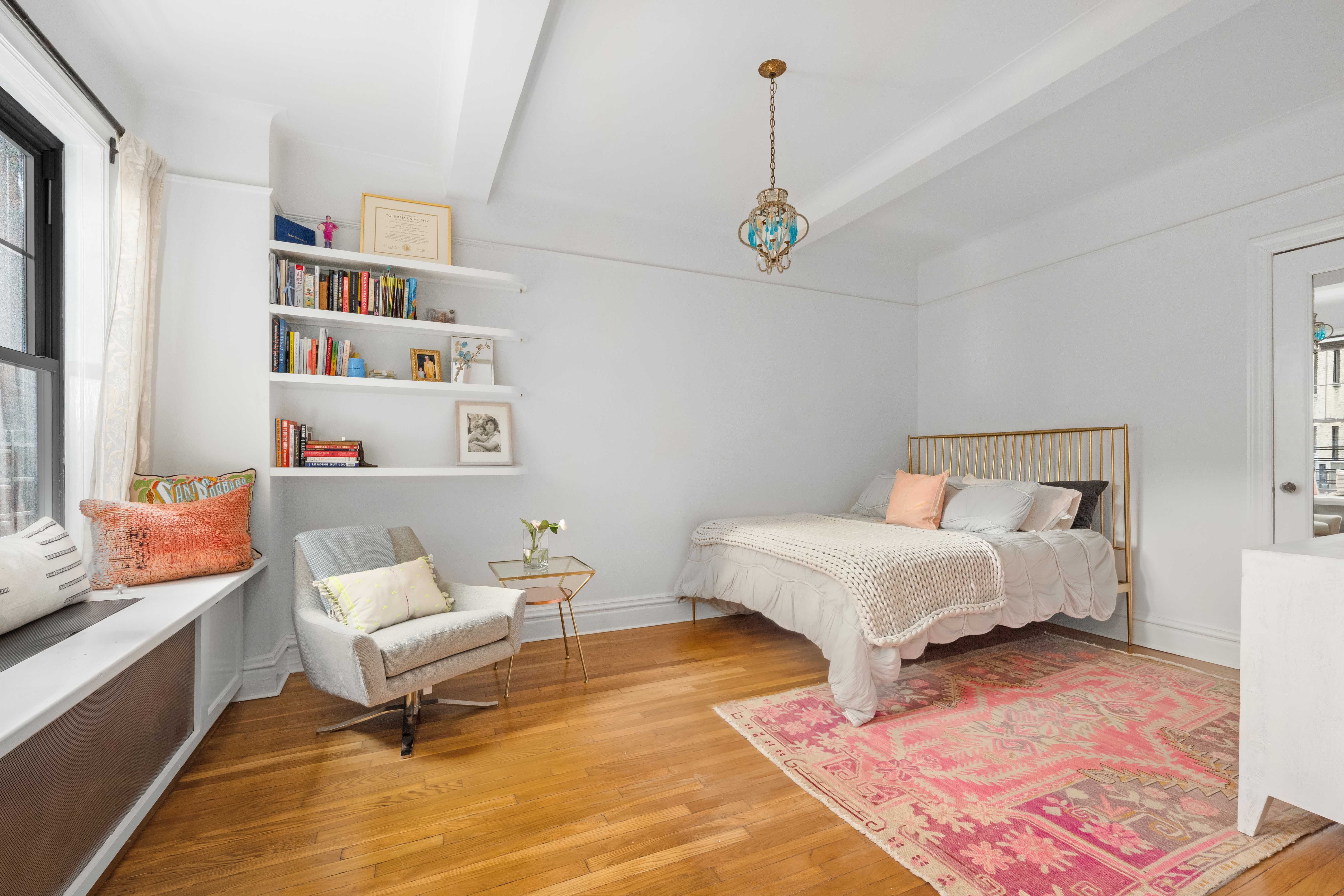 170 2nd Avenue, Unit 4A Manhattan, NY 10003 - Photo 6 of 11 a spacious bedroom with a bed and a book shelf