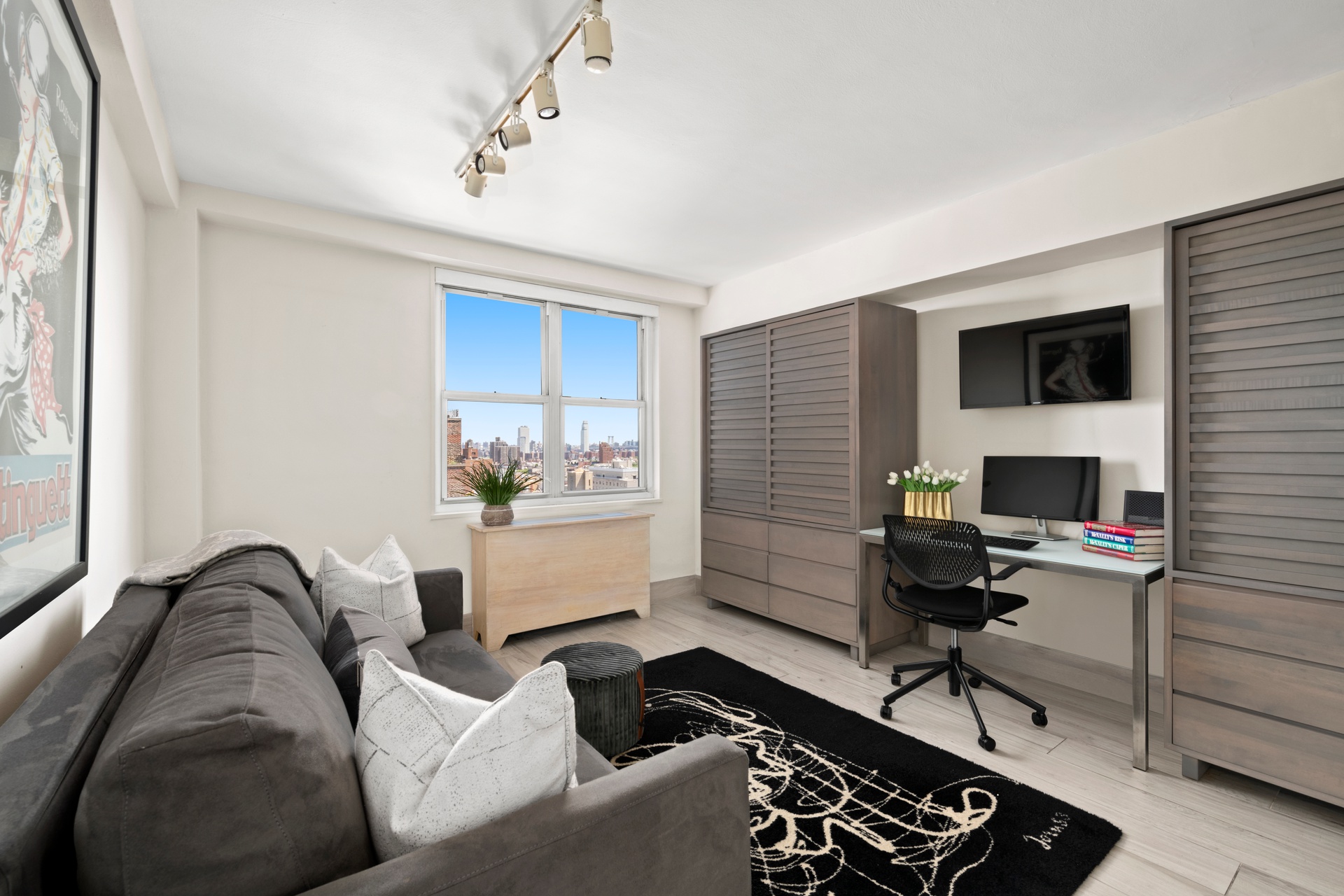 142 East 16th Street, Unit 22B Manhattan, NY 10003 - Photo 9 of 15 a living room with furniture and a flat screen tv