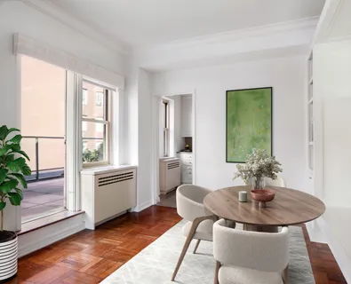 a dining room with furniture and wooden floor