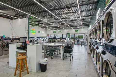 a view of a patio with dining table and chairs