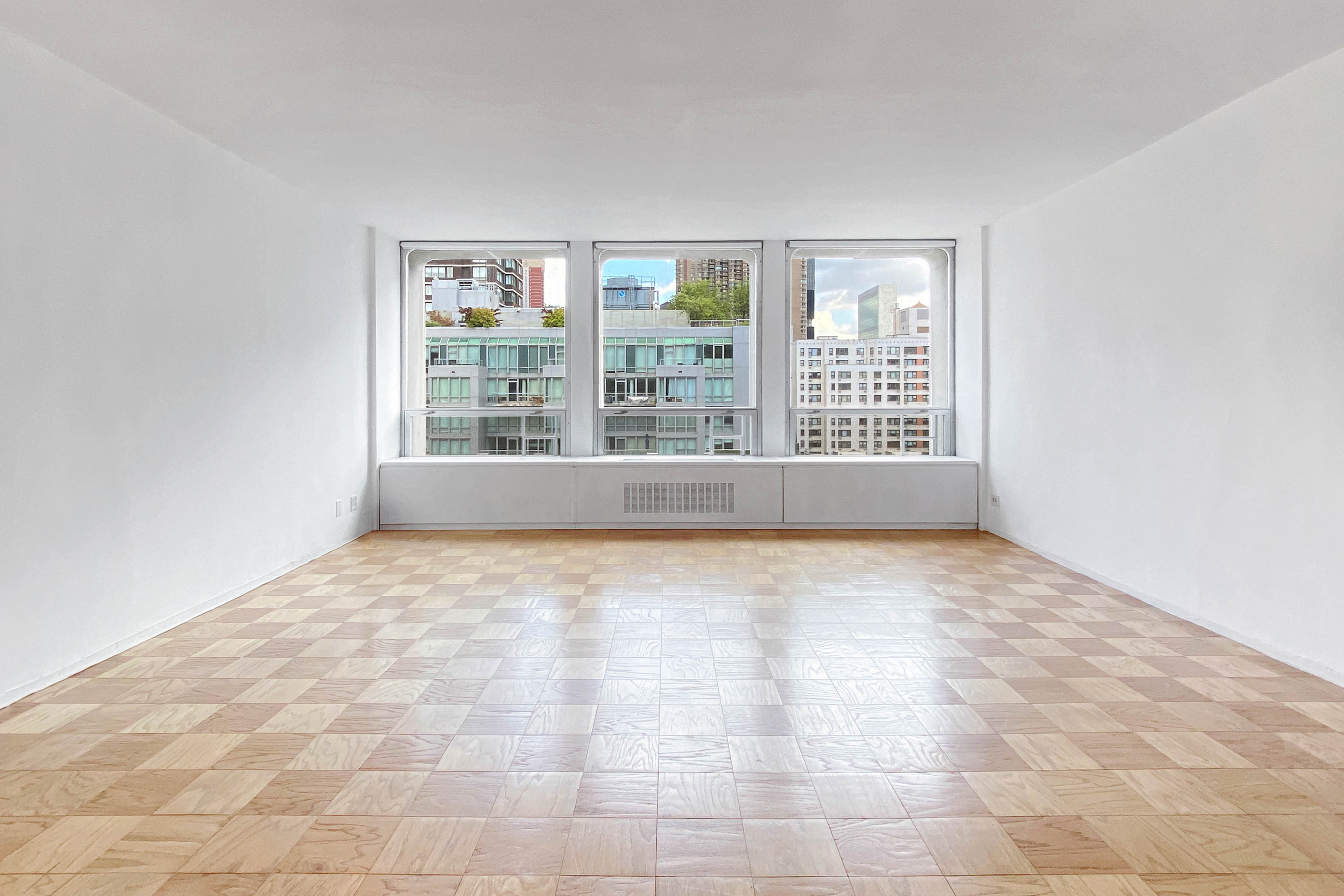 300 East 33rd Street, Unit 9D Manhattan, NY 10016 - Photo 4 of 17 a view of an empty room with a window