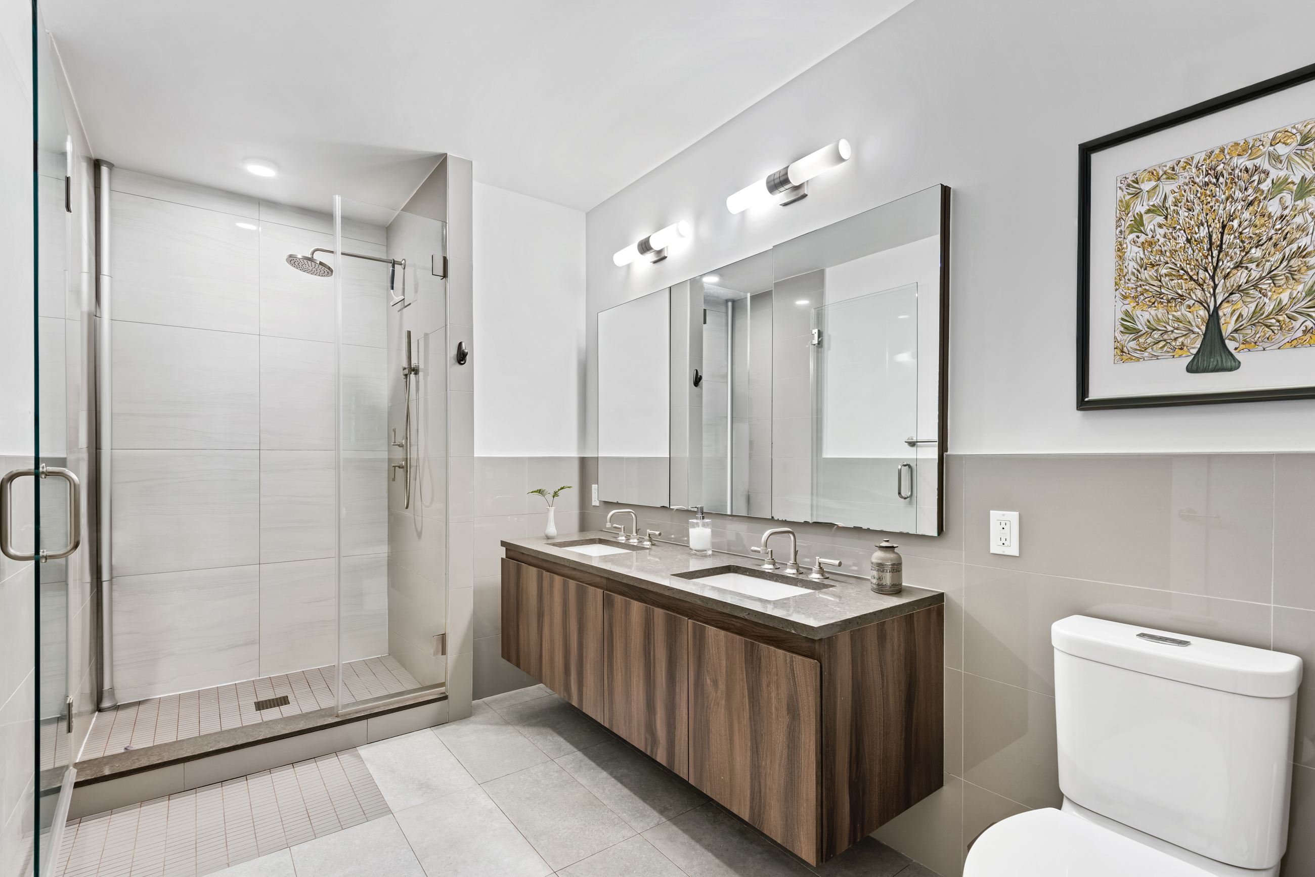 147 Hope Street, Unit 2D Brooklyn, NY 11211 - Photo 4 of 13 a bathroom with a granite countertop sink a toilet a mirror and shower