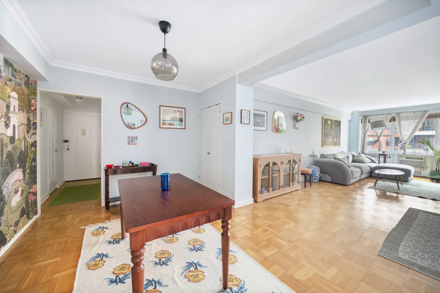 a living room with furniture and wooden floor