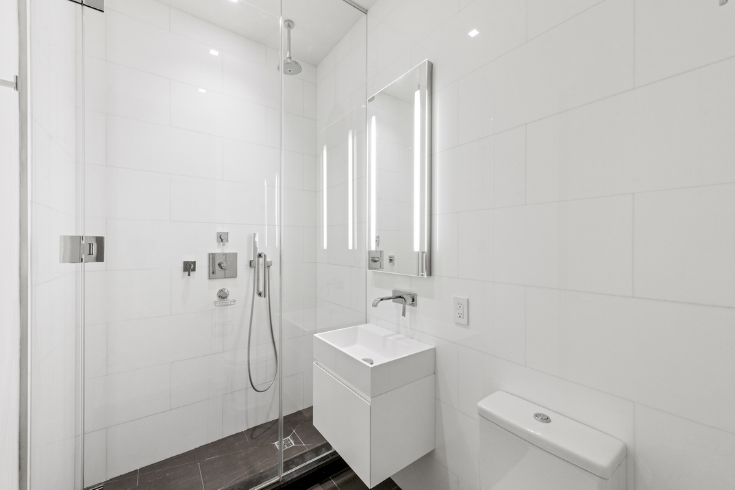 11 North Moore Street, Unit 2B Manhattan, NY 10013 - Photo 8 of 12 a bathroom with a sink a toilet and shower