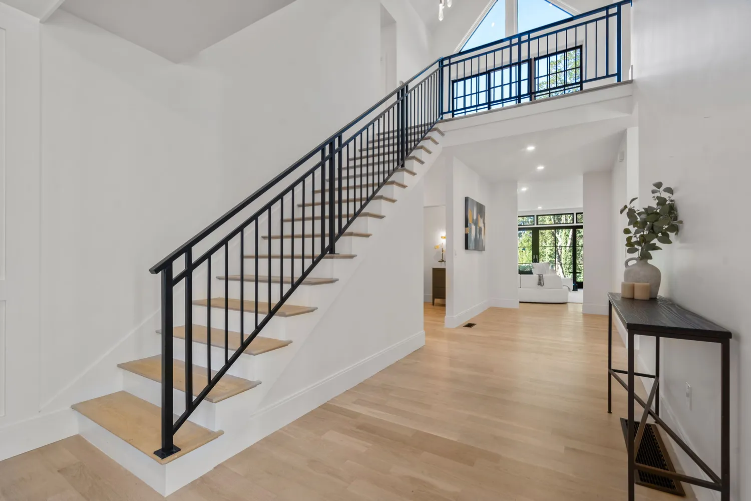 a view of staircase with wooden floor and a chandelier