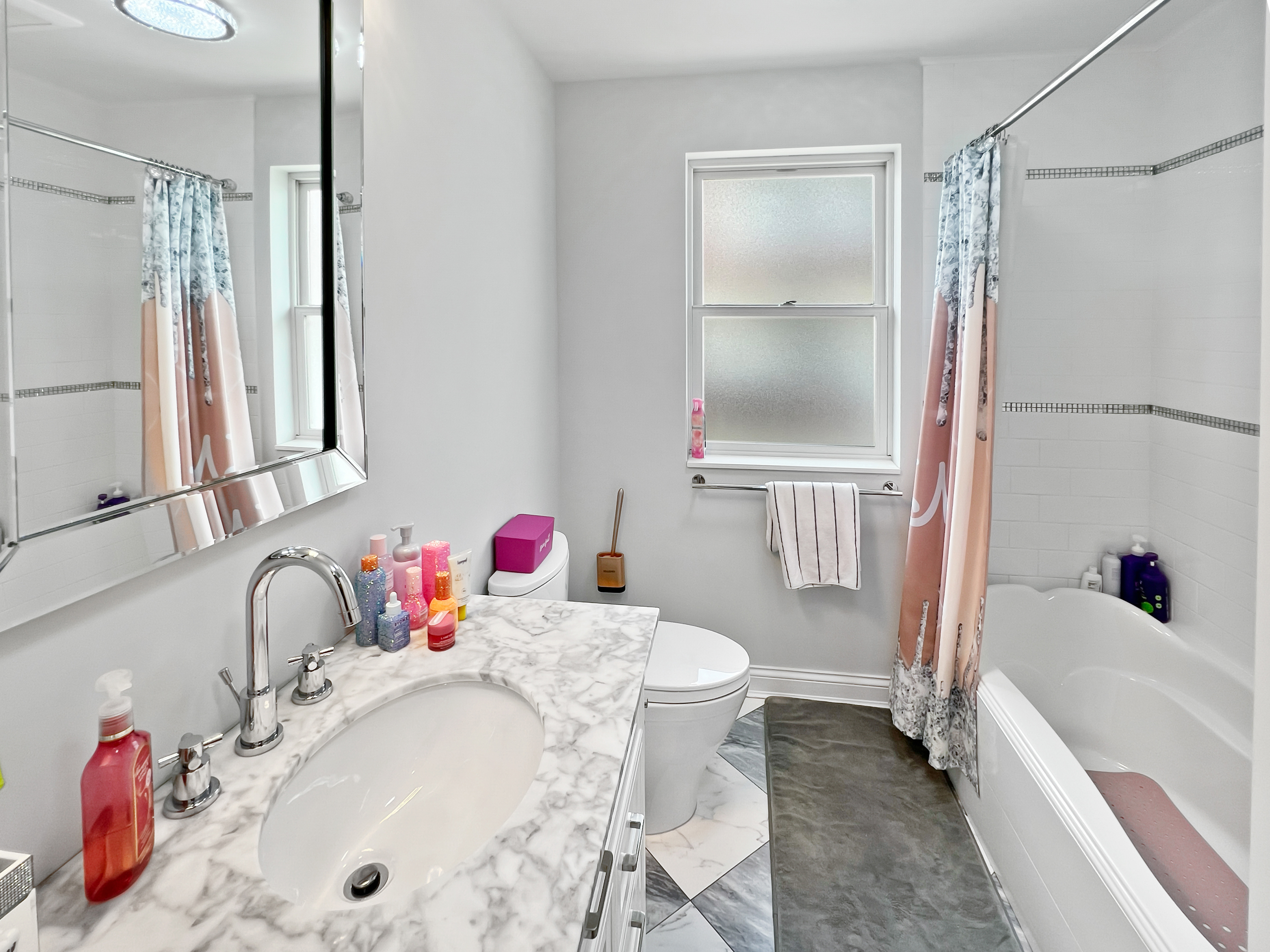 5021 Surf Avenue Brooklyn, NY 11224 - Photo 17 of 32 a bathroom with a tub sink and mirror