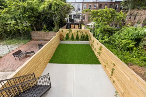 a view of a swimming pool with a patio and a yard