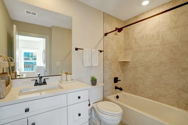 a bathroom with a sink a toilet and a bathtub